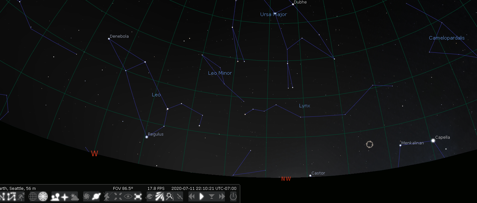 a Seattle horizon view from Stellarium here for July 11 at 10pm. It will show a small marker next to the Northwest horizon between the constellations of Auriga to the right/North, Ursa Major (the Big Dipper) above, and Leo to the left/South. The marker is about an eighth of the from Auriga to Leo, it is much closer to Leo. It is about a quarter of the way from Auriga to Ursa Major, closer to Auriga